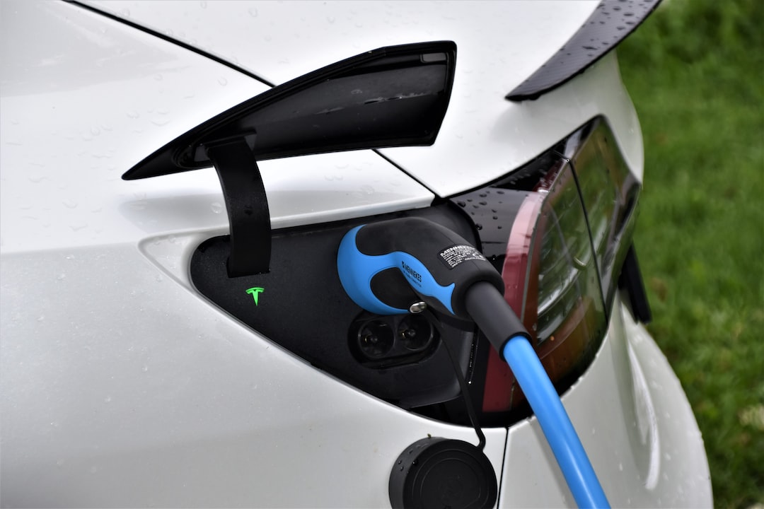  an image showcasing a car battery being connected to a smart charging device, surrounded by a clean and well-organized garage