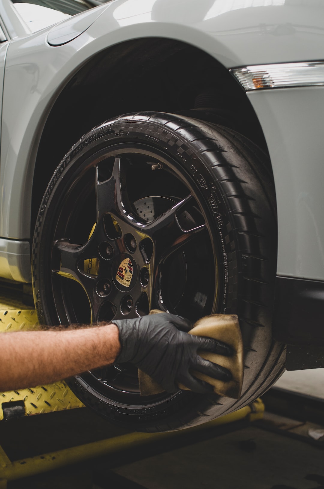 An image showcasing a gleaming car exterior after a professional detailing, with meticulously polished surfaces and flawlessly cleaned rims, emphasizing how car detailing saves you time and effort